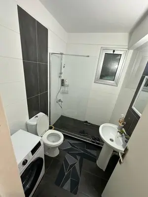 a bathroom with a toilet and a sink and a shower at 5 minutes to the sea in Kyrenia new port in Meniko