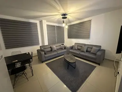 a living room with two couches and a table at 5 minutes to the sea in Kyrenia new port in Meniko
