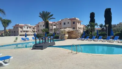 a swimming pool with chairs and a resort at Pyla Village Resort E108 in Pyla