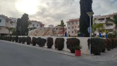 a row of hedges on a wall next to a street at Pyla Village Resort E108 in Pyla