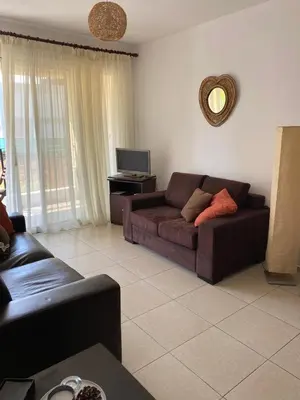 a living room with a couch and a tv at Pyla Village Resort E108 in Pyla