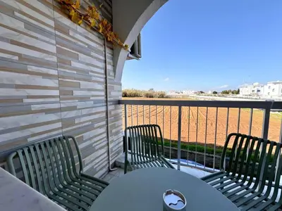 a balcony with two chairs and a table with a view at Stay With Oleg 102A in Paralimni