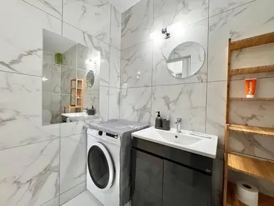 a bathroom with a washing machine and a sink at Stay With Oleg 102A in Paralimni
