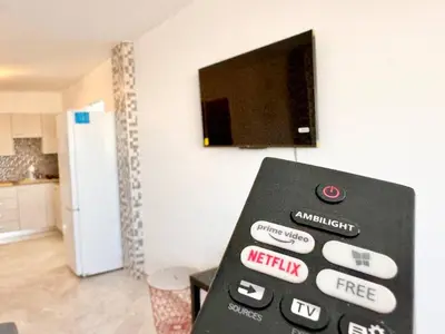 a tv on a wall in a kitchen with at Stay With Oleg 102A in Paralimni