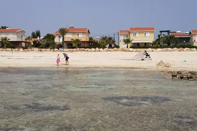 two people flying a kite on the beach at On the beachfront, AYIA THEKLA, AGIA NAPA MARINA in Ayia Napa