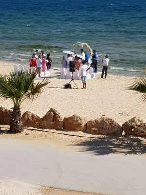 a group of people standing on a beach with the ocean at On the beachfront, AYIA THEKLA, AGIA NAPA MARINA in Ayia Napa