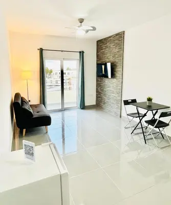 a living room with a couch and a table at HeartCore Holiday Apartments in Ayia Napa