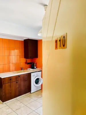 a kitchen with a washing machine and a washer at HeartCore Holiday Apartments in Ayia Napa