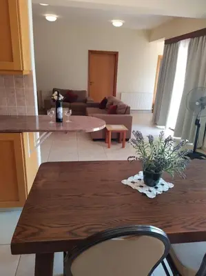 a living room with a table and a couch at The Tower Penthouse in Strovolos