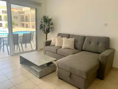 a living room with a couch and a table at Beautiful 2 Bed Ground Floor Apartment With Pool in Paralimni