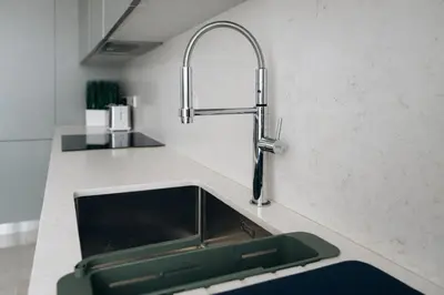 a kitchen counter with a sink and a faucet at New Luxury 2BR Seaview Apt, Sun City, Pool and Beach in Ayia Napa