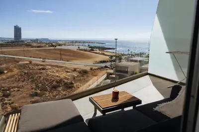 a balcony with a table and a view of the ocean at New Luxury 2BR Seaview Apt, Sun City, Pool and Beach in Ayia Napa