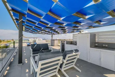a patio with blue ceilings and chairs on a balcony at Levanda Hills Escape in Protaras in Paralimni