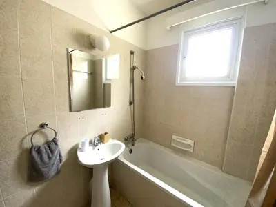 a bathroom with a sink and a bath tub and a sink at 2 Beachside Apts, 5min Walk to Shore with Internet in Larnaka