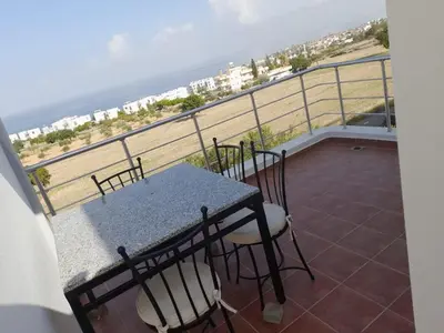 a table and chairs on a balcony with the ocean at Crystal Bay Marina B3-5 in Troulli
