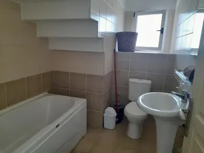 a bathroom with a tub and a toilet and a sink at Crystal Bay Marina B3-5 in Troulli