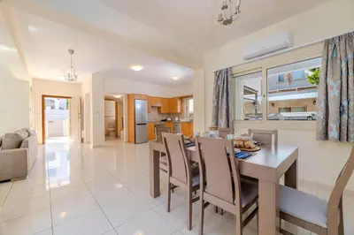 a dining room and living room with a table and chairs at Anthorina Greco Villa #10 in Protaras