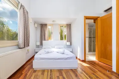 a bedroom with two beds and a window at Anthorina Greco Villa #10 in Protaras