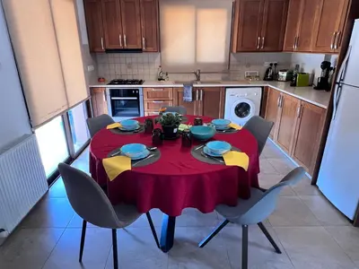 a kitchen with a table with a red table cloth on it at Villa Callione - Amazing view in Kyperounda