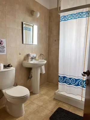 a bathroom with a toilet and a sink and a shower at Villa Callione - Amazing view in Kyperounda