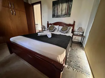 a bedroom with a large bed with two pillows at Villa Callione - Amazing view in Kyperounda