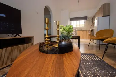 a living room with a table with a plant on it at Modern 2BR Steps from Beach in Voroklini