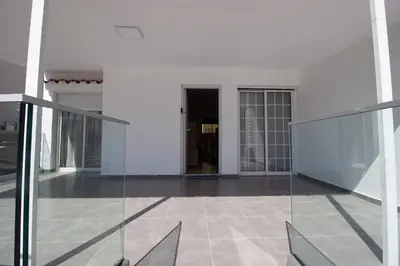 a glass corridor with a door in a building at Modern 2BR Steps from Beach in Voroklini