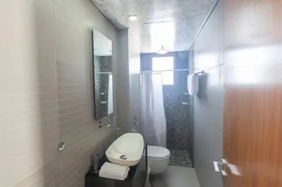 a white bathroom with a toilet and a shower at Ayia Napa Satin Villa SVI1 in Ayia Napa