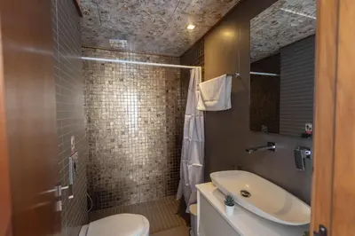 a bathroom with a sink and a toilet and a shower at Ayia Napa Satin Villa SVI1 in Ayia Napa