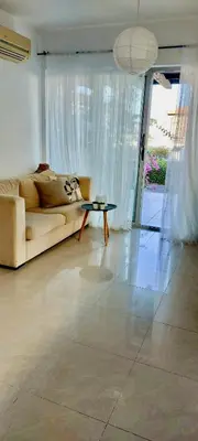 a living room with a couch and a table at Boho Beach Apartment in Tatlisu