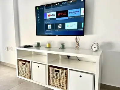 a tv on a white entertainment center with a television on it at STAY Ease Apartment in Ayia Napa