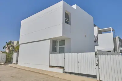 a white house with a white fence at Pearl Villas in Protaras