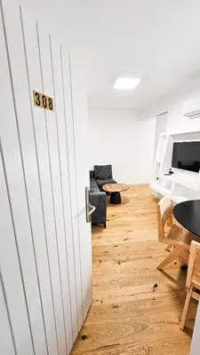 a living room with a table and a couch at Larnaca Beach Bliss Apartment in Larnaka