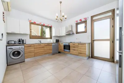 a kitchen with a washing machine and a washer at Kymma River Villa #4 in Ayia Napa