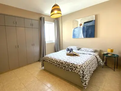 a bedroom with a bed with a table on it at 2 Combined Apts, Fast Wi-Fi, 5 Min Walk to Beach in Larnaka
