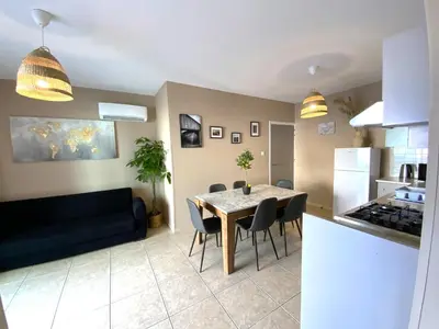 a kitchen and a dining room with a table and chairs at 2 Cozy Apts, Fast Internet, 5 Min Walk to Beach! in Larnaka