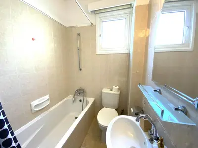 a bathroom with a tub and a toilet and a sink at 2 Cozy Apts, Fast Internet, 5 Min Walk to Beach! in Larnaka