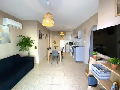 a living room and kitchen with a couch and a table at Spacious 3Apt Combo, Fast WiFi, 5Min Walk to Beach in Larnaka