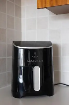 a black coffee pot sitting on top of a counter at Cozy Apartment with Sea View in Larnaka