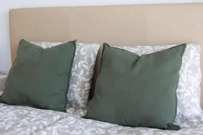 two pillows sitting on top of a bed at Cozy Apartment with Sea View in Larnaka