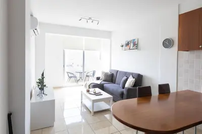 a living room with a couch and a table at Cozy Apartment with Sea View in Larnaka