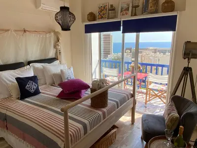 a bedroom with a bed with a view of the ocean at Amathounta Mare Vista Maison in Limassol