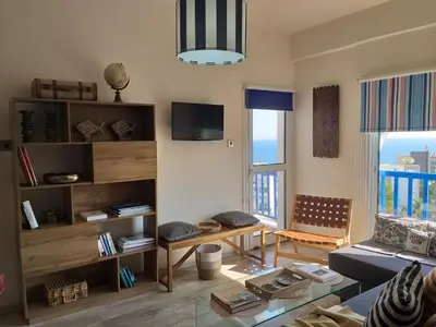 a living room with a couch and a table at Amathounta Mare Vista Maison in Limassol