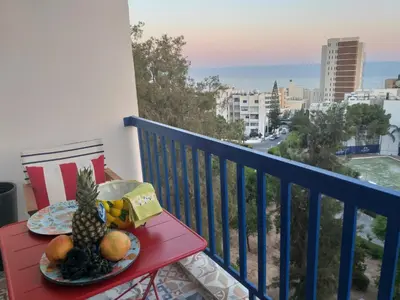 a table with a plate of fruit on a balcony at Amathounta Mare Vista Maison in Limassol
