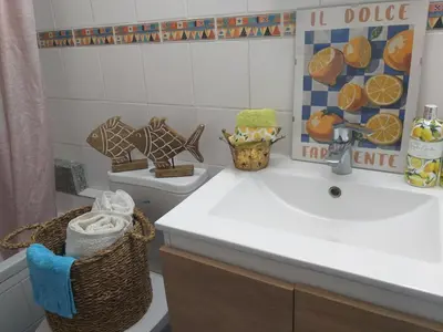 a bathroom with a white sink and a toilet at Amathounta Mare Vista Maison in Limassol