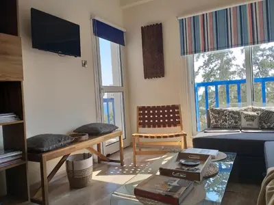 a living room with a couch and a table at Amathounta Mare Vista Maison in Limassol