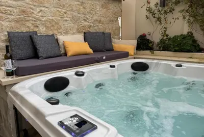 a jacuzzi tub in a living room with a couch at Vouno Vouni Cottage in Vouni