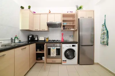 a kitchen with a refrigerator and a washing machine at Chromata means colorful for a much-needed sunny escape, check your stay! in Protaras