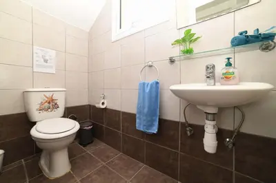 a bathroom with a toilet and a sink at Chromata means colorful for a much-needed sunny escape, check your stay! in Protaras