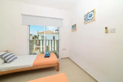 a bedroom with a bed and a balcony at Chromata means colorful for a much-needed sunny escape, check your stay! in Protaras